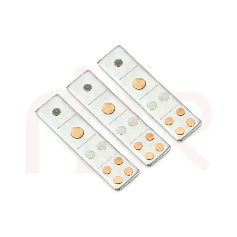 Three silver metal strips with copper and silver studs for Vastu remedies.