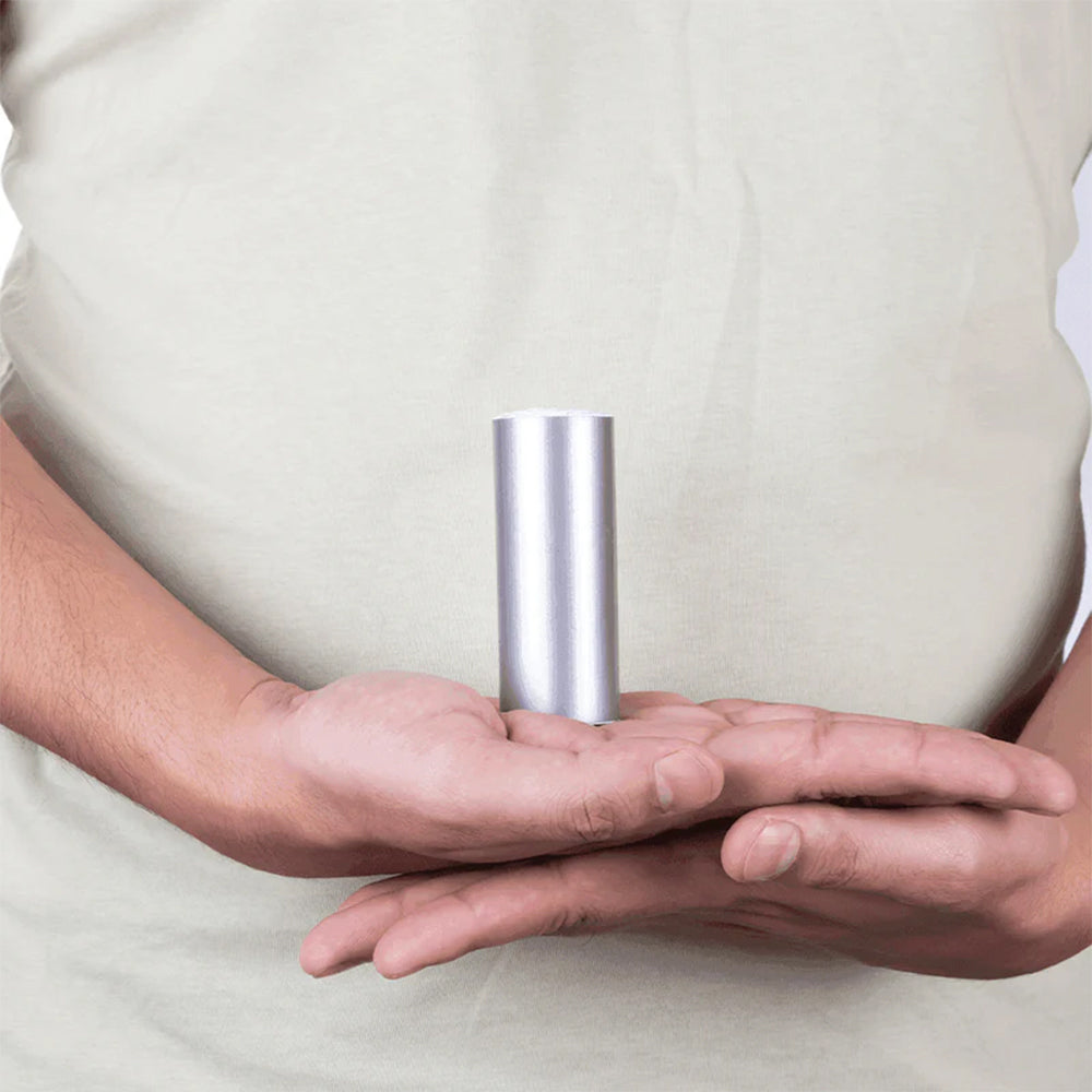 Person holding a silver MahaVastu metal strip tape roll for Vastu Shastra remedies