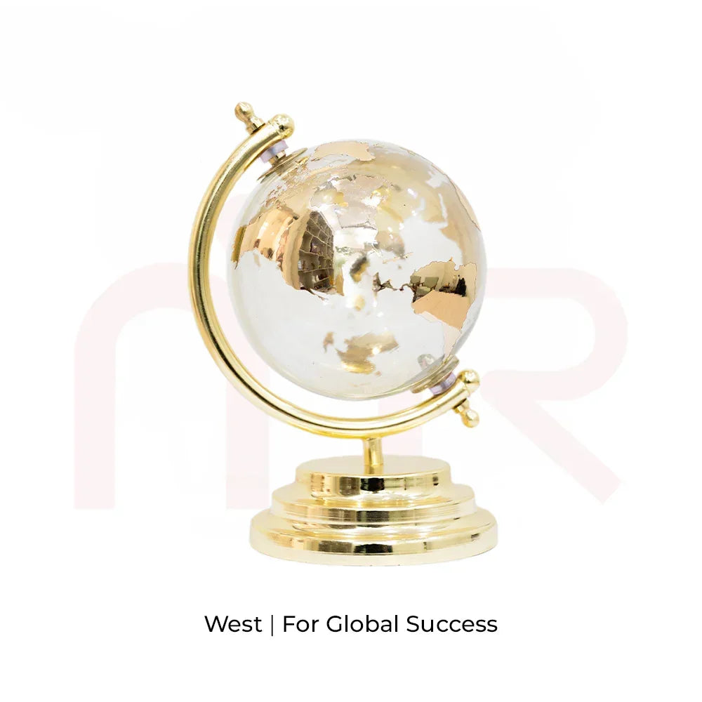Small gold and clear globe on a stand, used as a Vastu remedy for global success