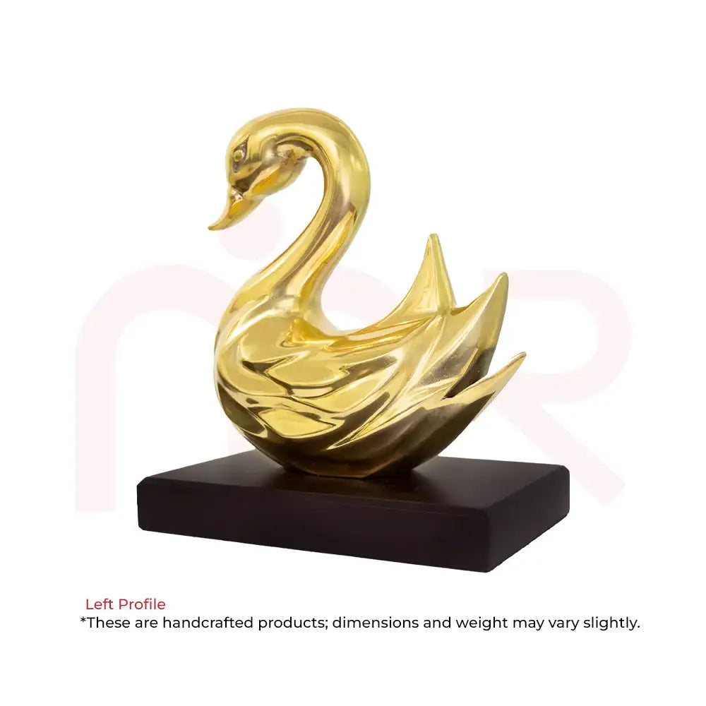 Golden swan sculpture on a black base for Vastu prosperity and positive energy.