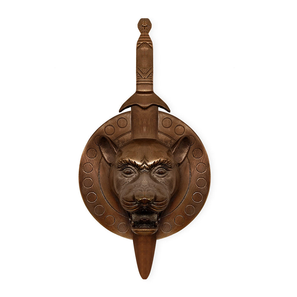 Decorative wooden sword and shield - maha vastu remedy, featuring intricate carvings and circular patterns, with a lion face embossed on the central space on the shield.