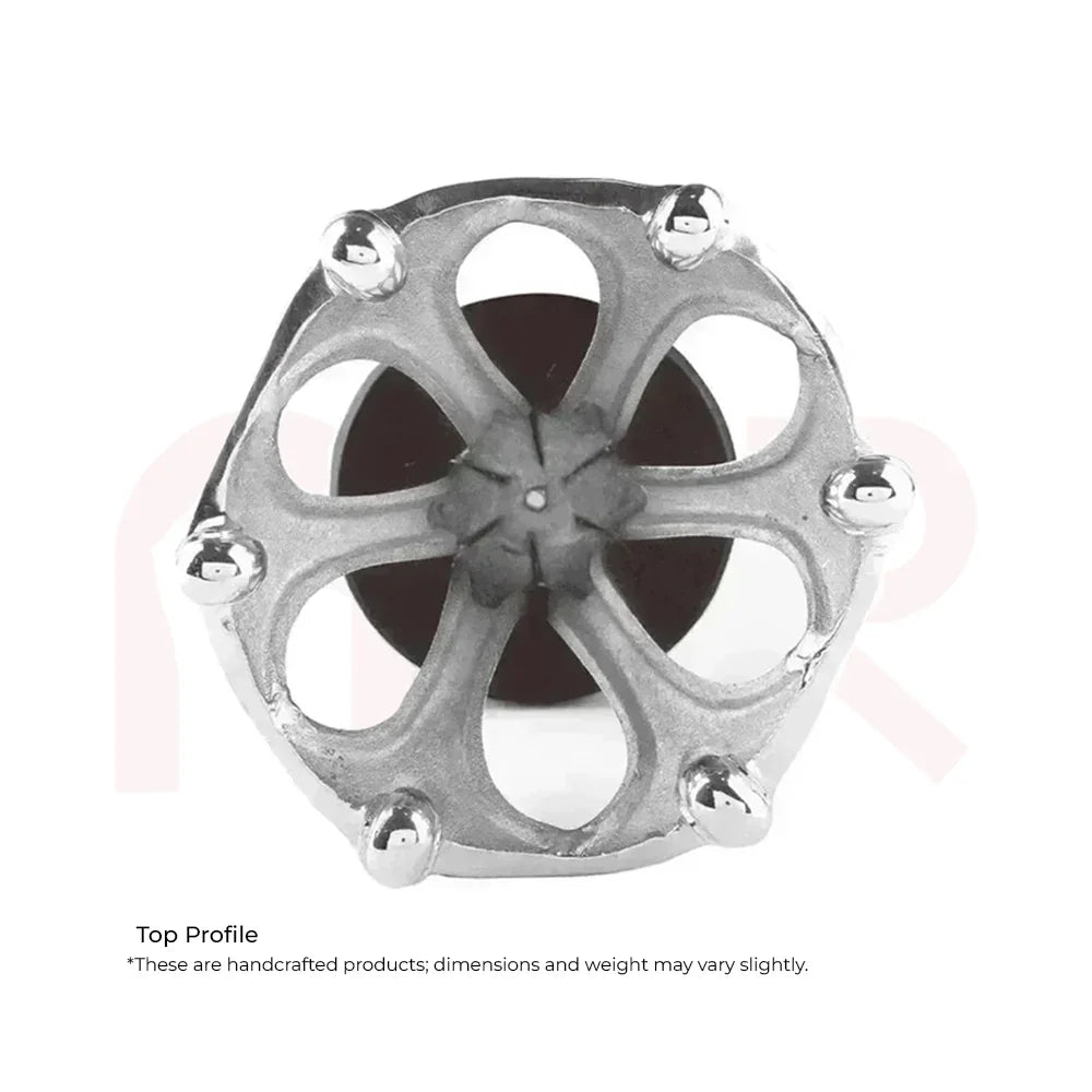 Top view of a handcrafted metallic Maha Vastu remedy tool with intricate floral design.