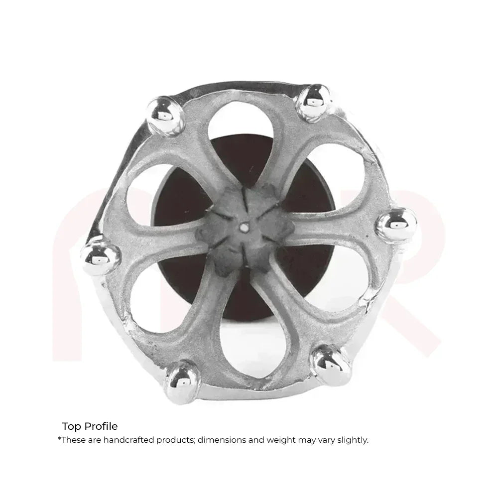 Top view of a handcrafted metallic Maha Vastu remedy tool with intricate floral design.