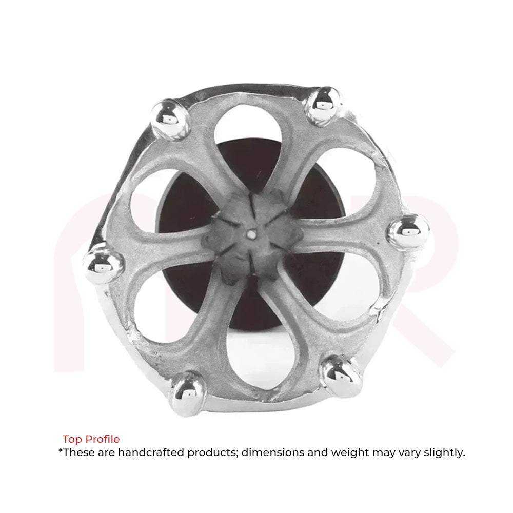Top view of a handcrafted metallic Maha Vastu remedy tool with intricate floral design.