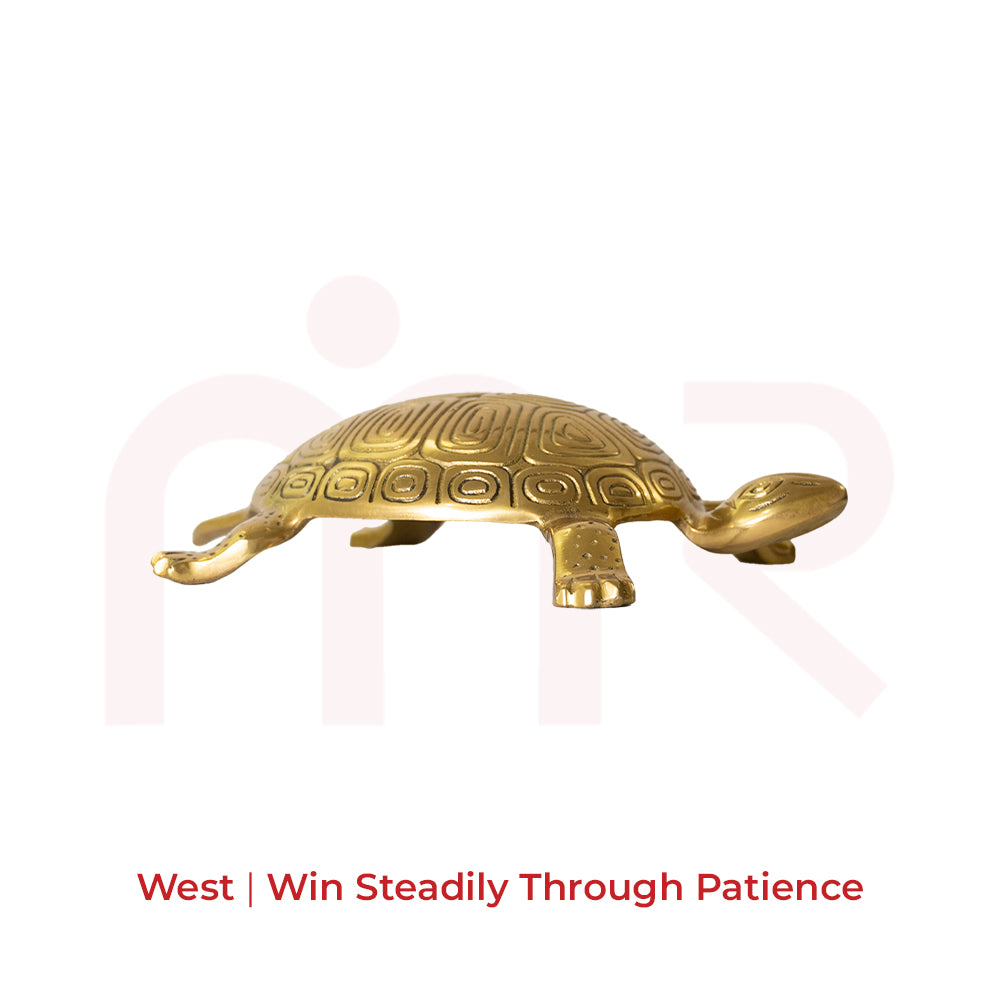 Golden brass tortoise for Vastu, symbolizing unstoppable victory, on a white background.