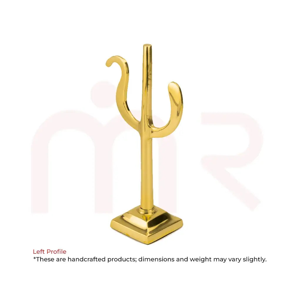 Golden brass Vastu remedy trident symbol on a square pedestal base.
