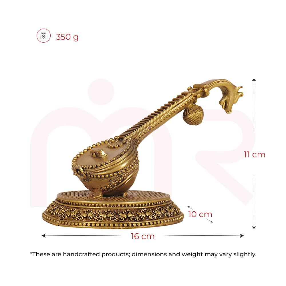 Handcrafted golden Veena idol for Vastu, 11x16x10 cm, decorative tabletop remedy.