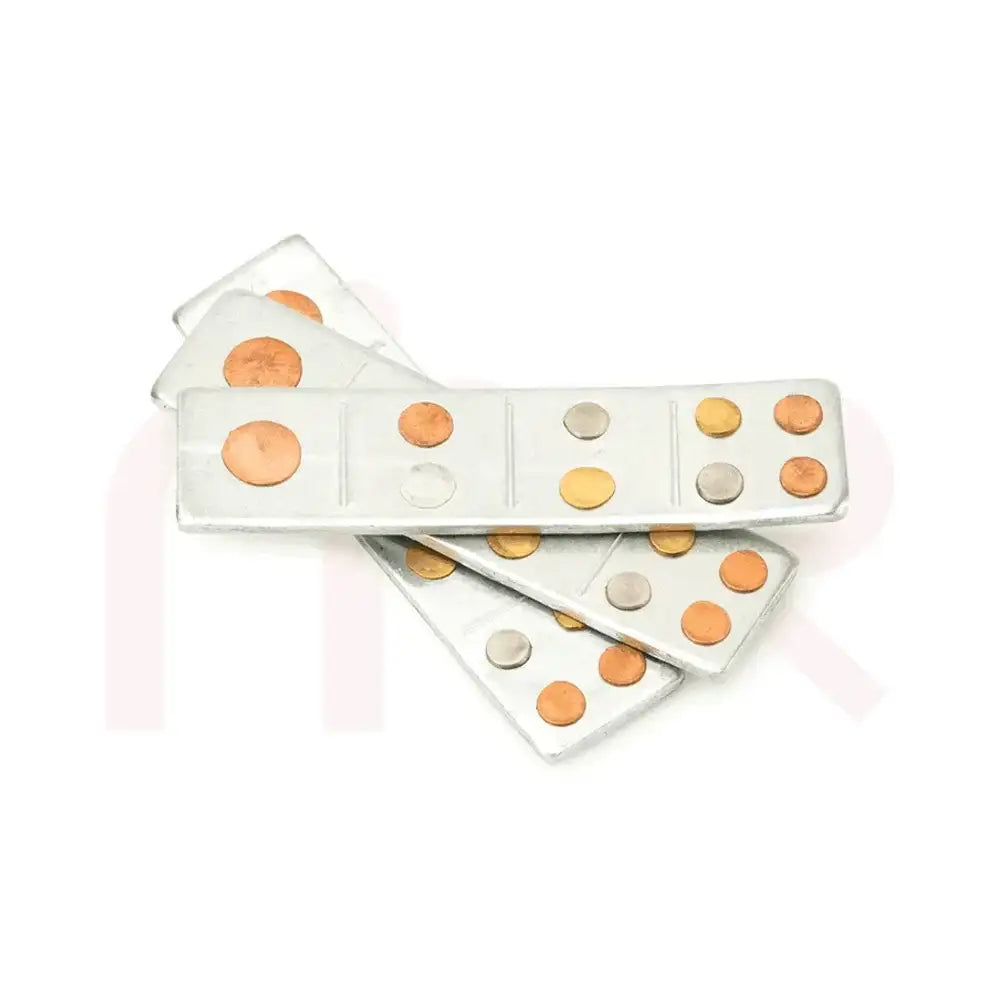 Set of silver metal strips with copper and brass dots for Vastu Shastra remedies.