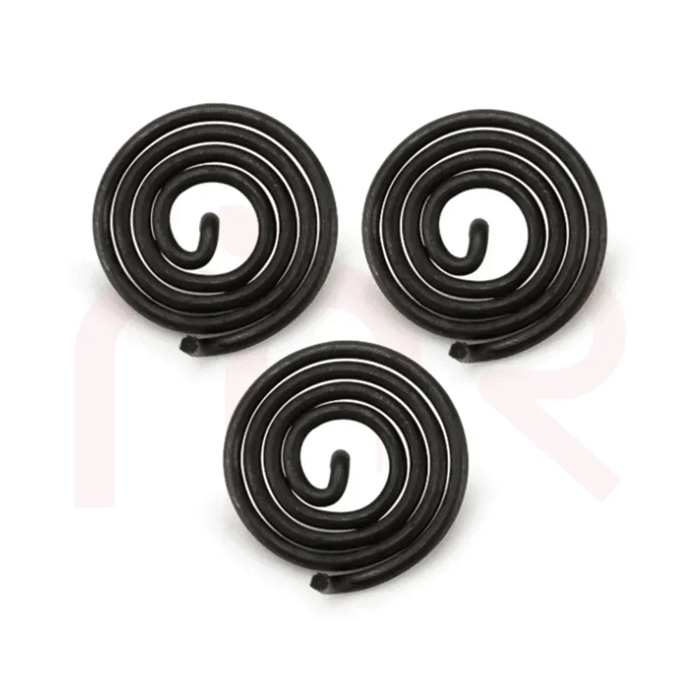 Three black metal spiral coils for MahaVastu Vastu remedies on white background