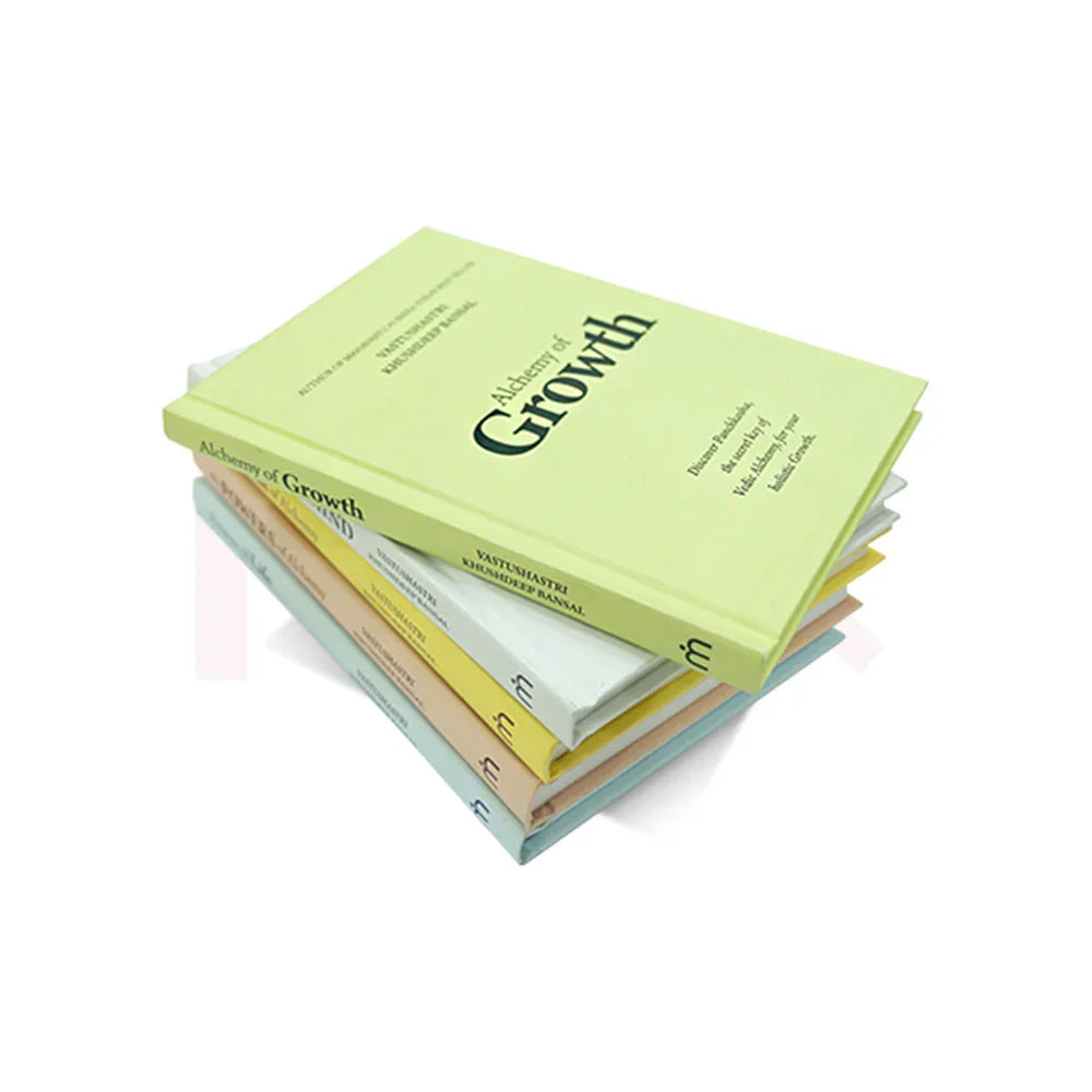Stack of Alchemy of Growth Vastu Shastra remedy books on a white background