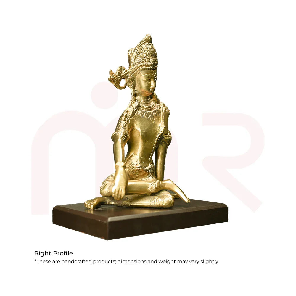 Brass god idol sitting on a dark base, used for Vastu remedies and home decor