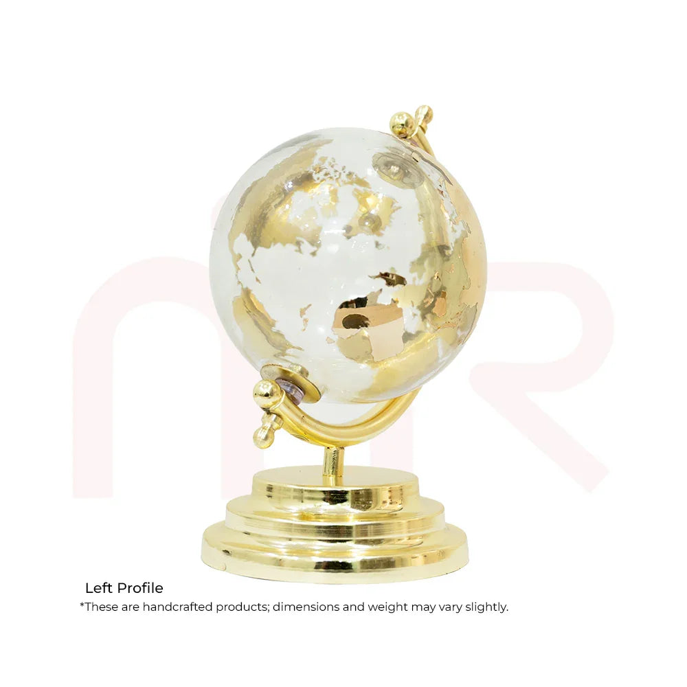 Small decorative golden and white globe on a gold stand, ideal for Vastu decor remedies