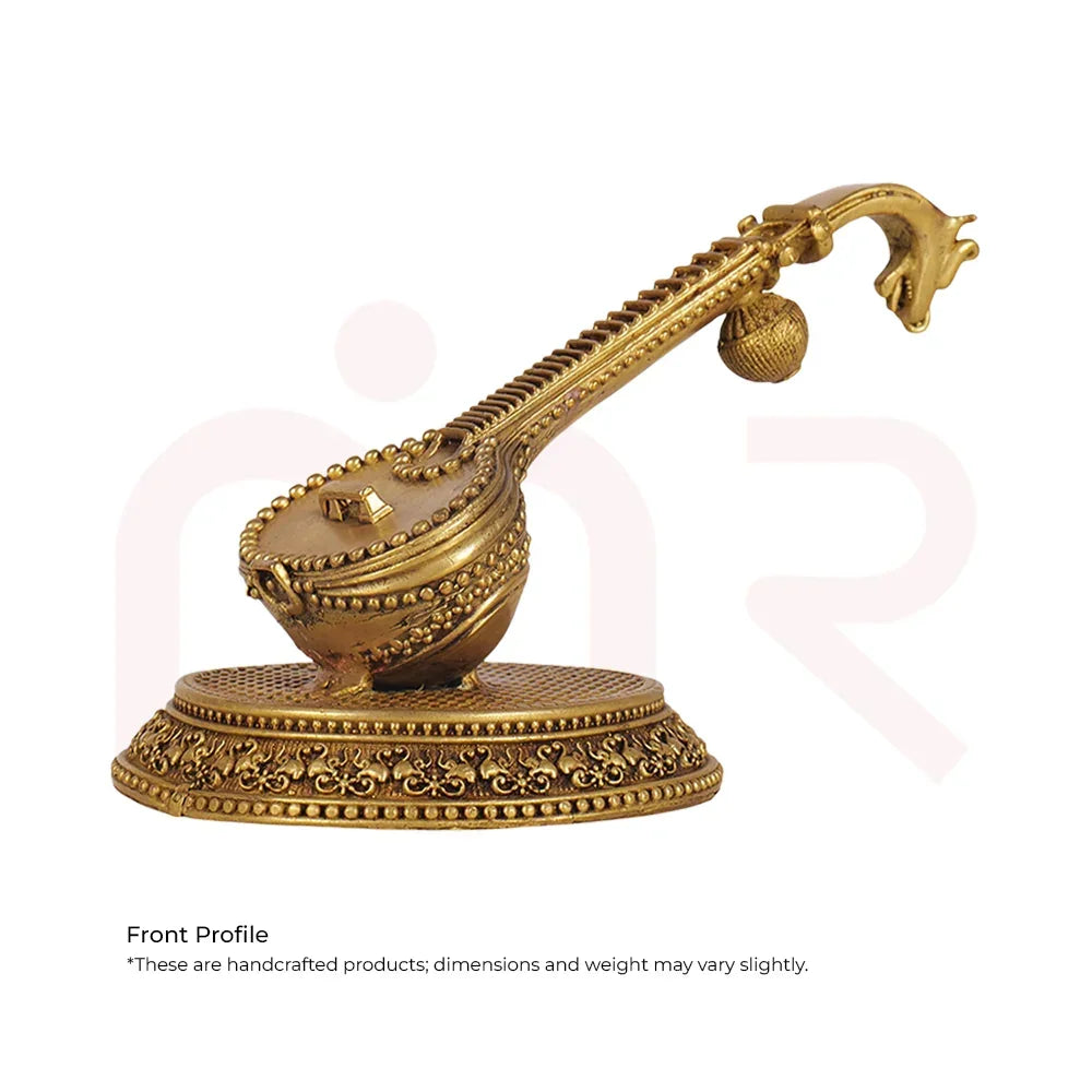Handcrafted golden veena idol with ornate design on decorative base for Vastu remedy